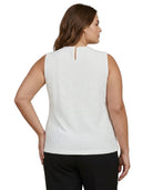 Woman wearing a white sleeveless Calvin Klein top and black pants on a white background