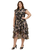 Woman wearing a Calvin Klein floral tiered dress on a white background