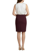 Woman wearing a white blouse and Calvin Klein burgundy skirt on a white background