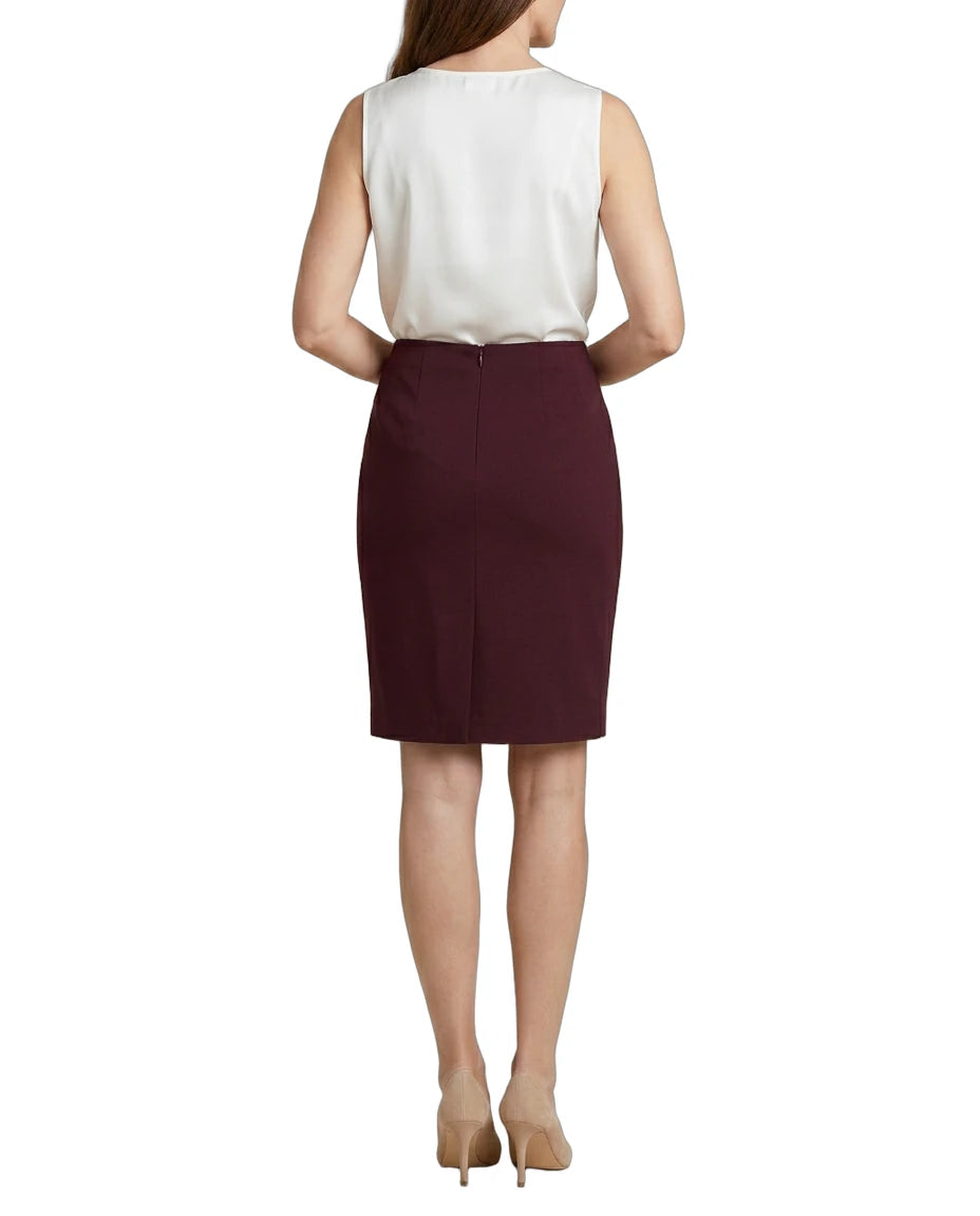 Woman wearing a white blouse and Calvin Klein burgundy skirt on a white background