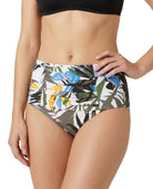 Person wearing a tropical leaf patterned Calvin Klein bikini bottom on a white background