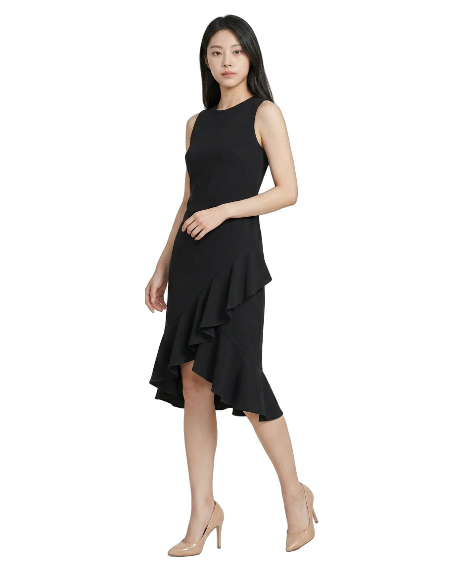 Woman wearing a black Calvin Klein dress with a ruffled skirt on a white background