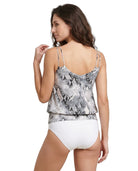 Woman wearing a patterned Calvin Klein tankini and white bikini bottoms on a white background