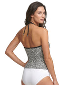 Woman wearing a black and white patterned Calvin Klein swimsuit on a white background