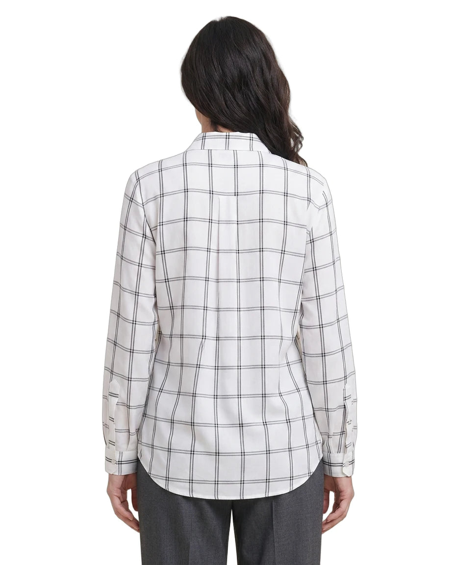Person wearing a white and black checkered Calvin Klein shirt on a white background