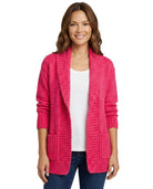 Woman wearing a bright pink cardigan over a white shirt on a white background