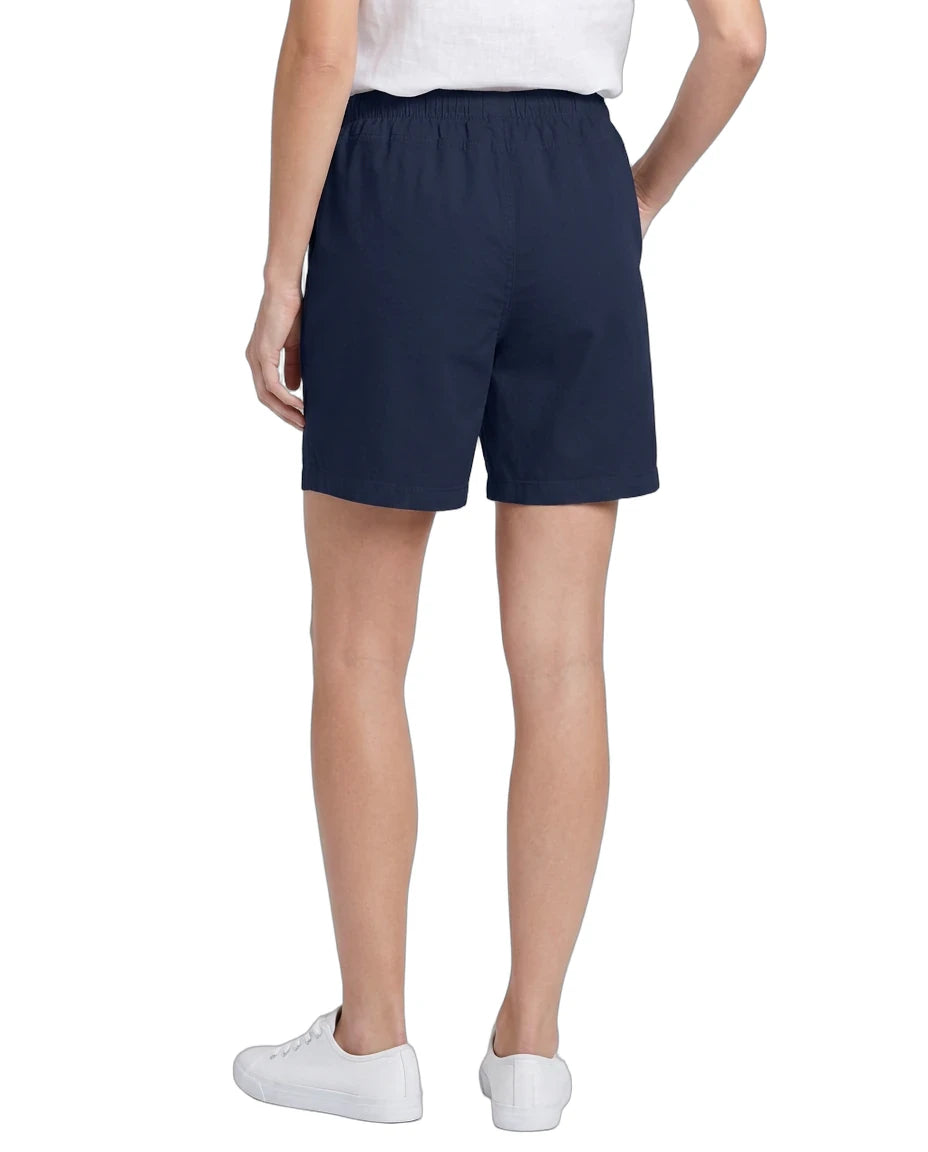 Person wearing navy shorts on a white background