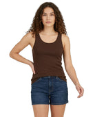 Woman wearing a brown tank top and blue shorts on a white background