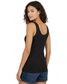 Woman wearing a black tank top and blue shorts on a white background