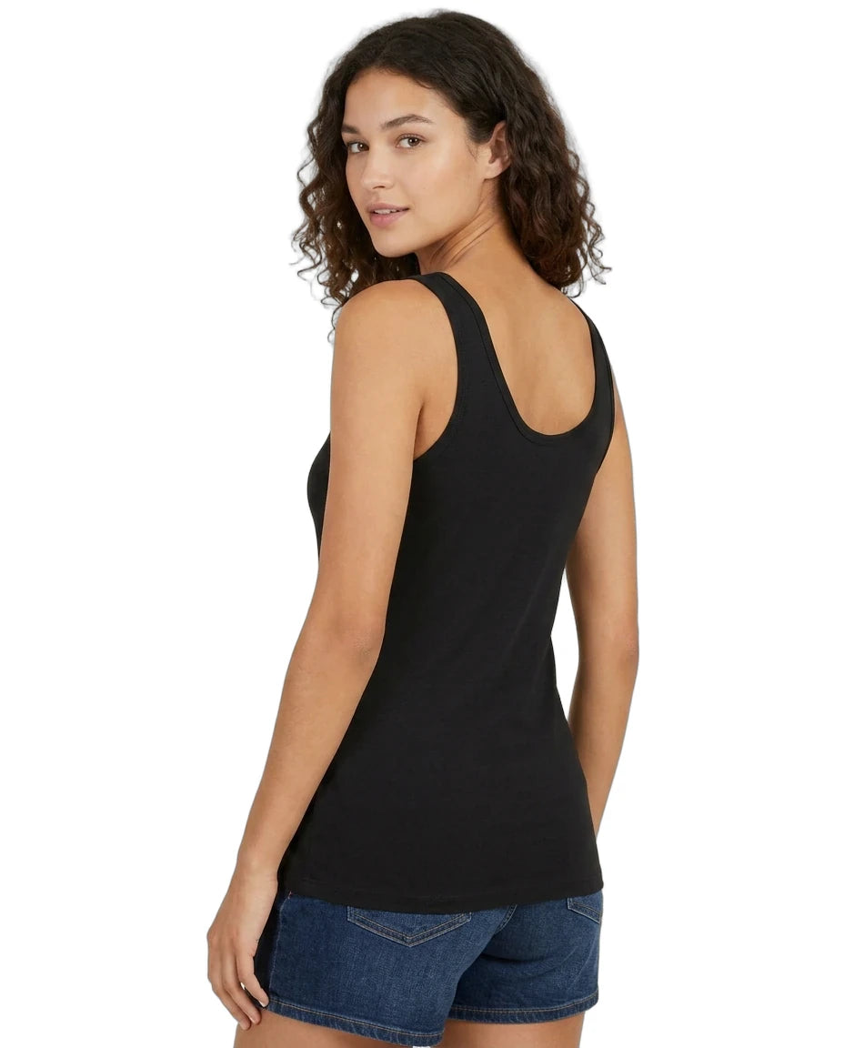 Woman wearing a black tank top and blue shorts on a white background