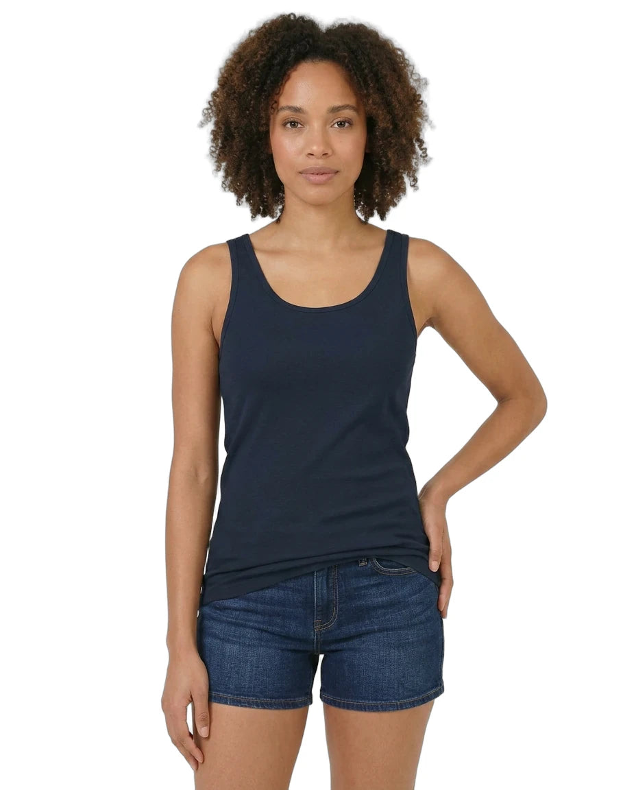 Woman wearing a navy tank top and denim shorts on a white background